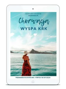 Przewodnik e-book Chorwacja: Wyspa Krk. Autorka Agnieszka Grudziąż (Cromania.pl / HelloCroatia.pl). Na okładce Most Krcki łączący wyspę z lądem, turkusowe morze i kobieta w czerwonej sukience.
